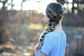 a girl with a long braid portrait on the street