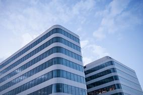 blue sky over business building with glass facade