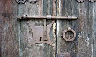 old wooden door with an iron lock