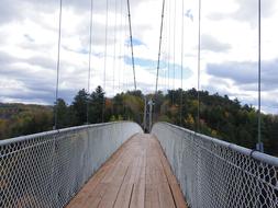 hike across the bridge into the woods