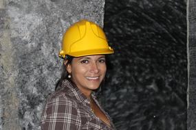 beautiful woman in yellow hard hat for safety