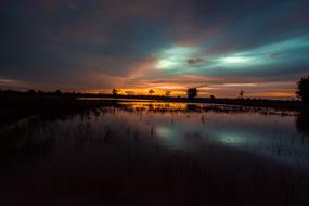 colorful sunset sky above wetland