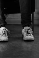 white sneakers on their feet