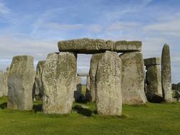 Stonehenge in the green grass against the sky