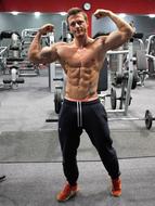 Muscular caucasian man posing in gym