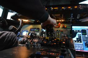 man controls the plane in the cockpit