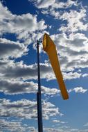 yellow windsock on the pole