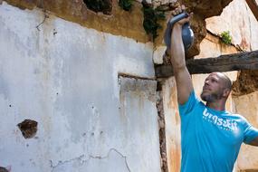 man exercises with a kettlebell