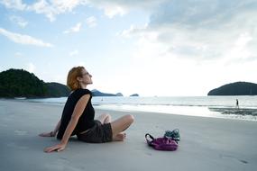 photo of a girl with a handbag on the beach
