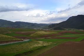 empty field of grass against a cliff