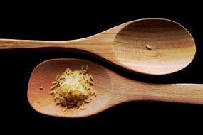 grains of rice on a wooden spoon