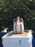 white pitcher decorated with flowers