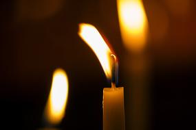 Close-up of the colorful, burning candles, at blurred background