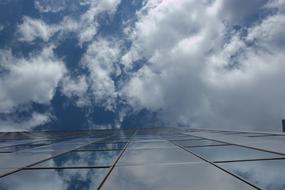 glass house against the clouds