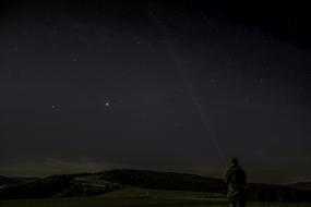 man in the night sky with stars