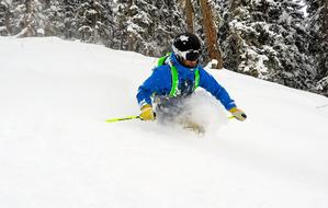 happy man rolls down snow slide