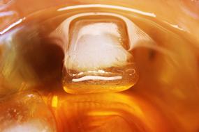 ice cube in a glass of juice
