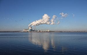 smoke from the pipes of the factory on the island