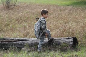 boy in camouflage suit with backpack