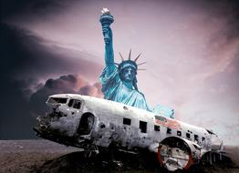 destroyed airplane in front of the statue of liberty