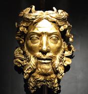 gold sculpture of a philosopher's head