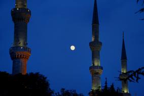 Beautiful minaret at blue sky with Moon background