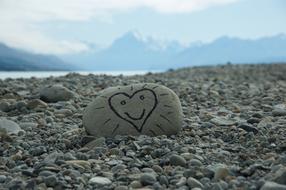 a picture of a heart on a rock on the beach