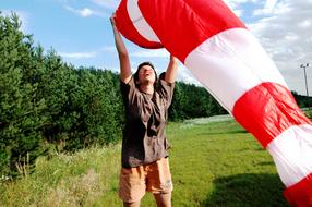 photo of a guy with a red striped windsock