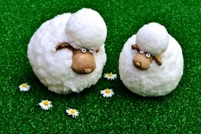 two toy sheep on the grass
