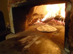 cooking pizza in the oven on fire