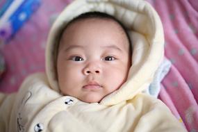 Portrait of the cute child in white coat