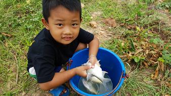 photo of asian Boy with fish