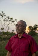 photo of an old man in a burgundy shirt