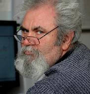 Portrait of the man with grey hair and beard with glasses