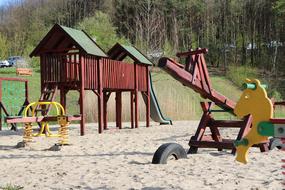 red sand house with swings