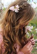 Profile portrait of the girl sniffing white fragrant flowers