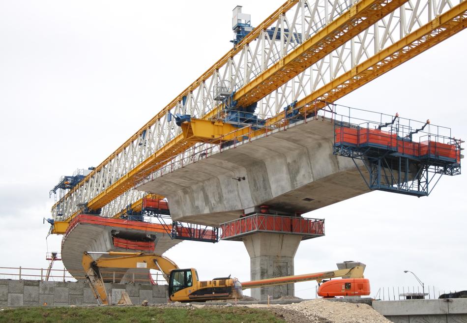 stone bridge with construction cranes