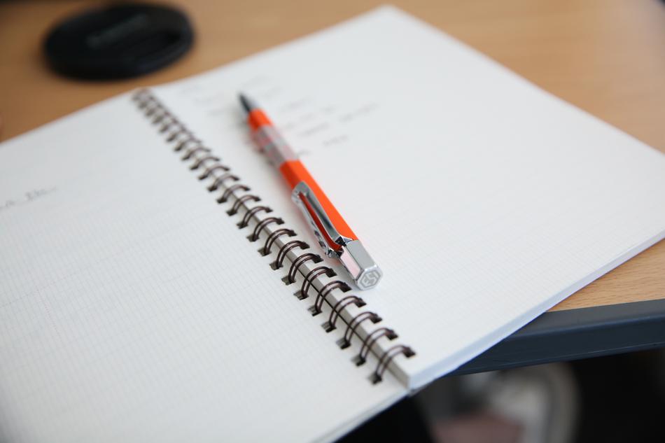 notebook with a pen on the table