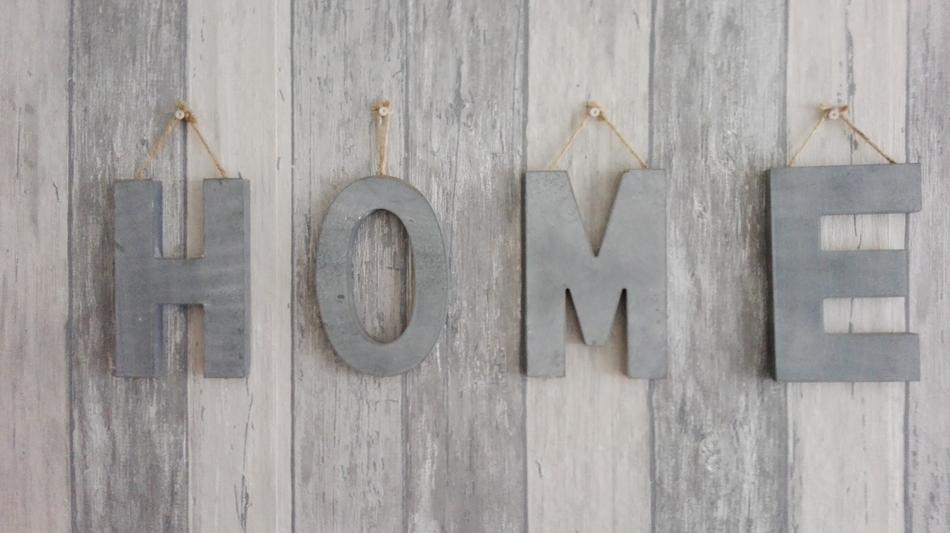 wooden inscription house on the wall