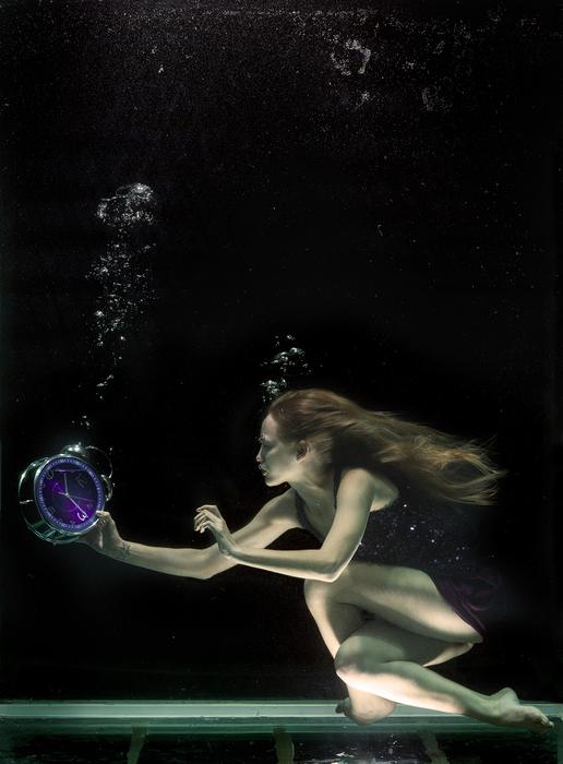 girl in the water with a clock