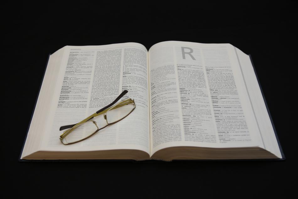 glasses lying on an open book