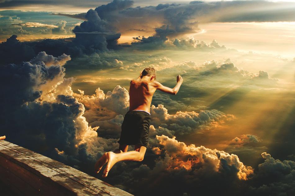boy jumping from a roof into the clouds