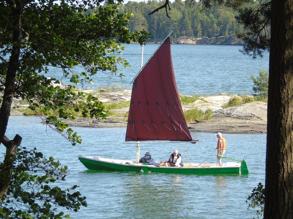 fishing boat with red sail