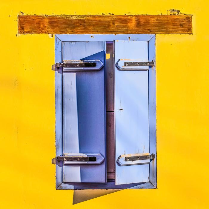 colored house with wooden shutters