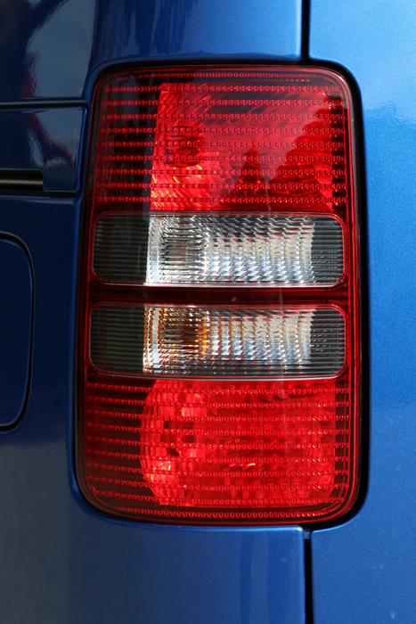 red headlight on the background of a blue car