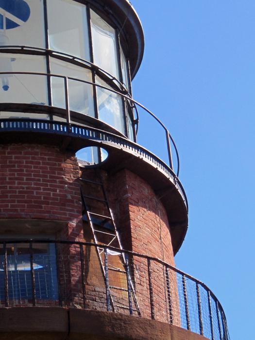 a tall lighthouse on a blue background