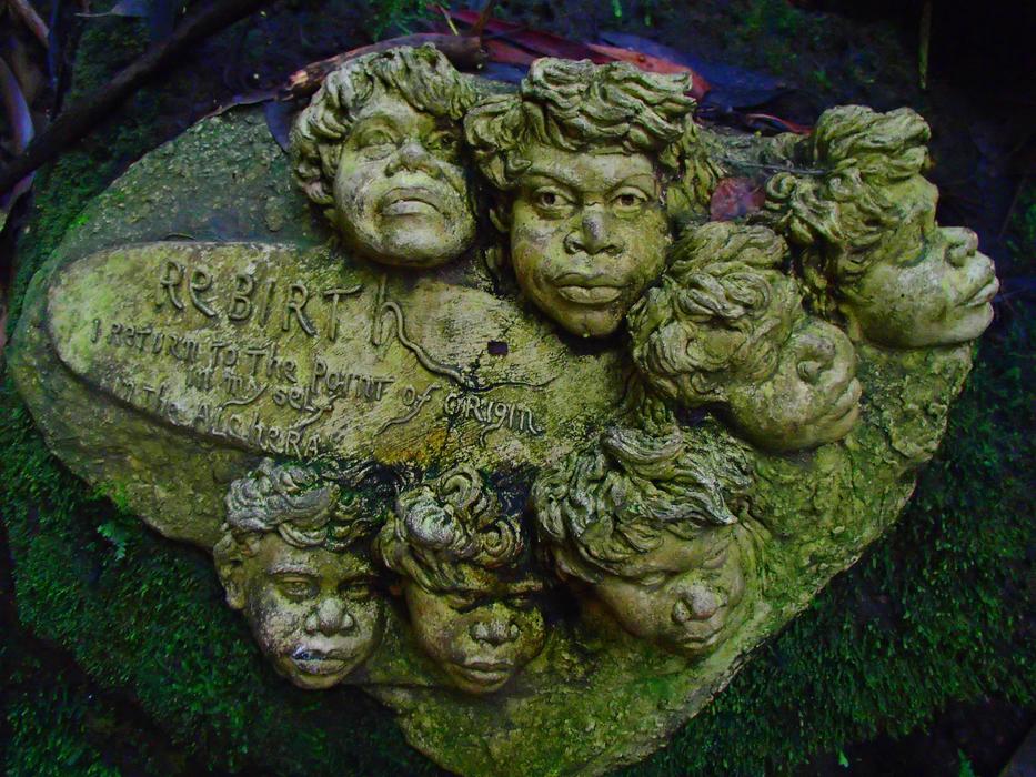 Old green statues with the man in rebirth