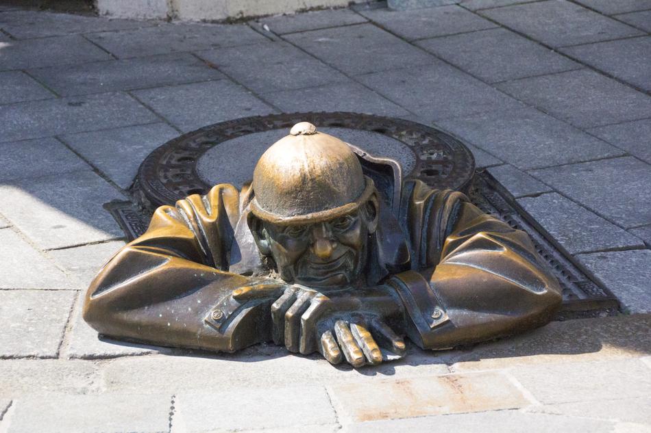 Bratislava statue of a fireman in a manhole