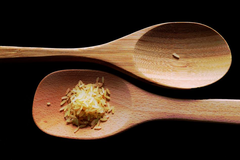 grains of rice on a wooden spoon