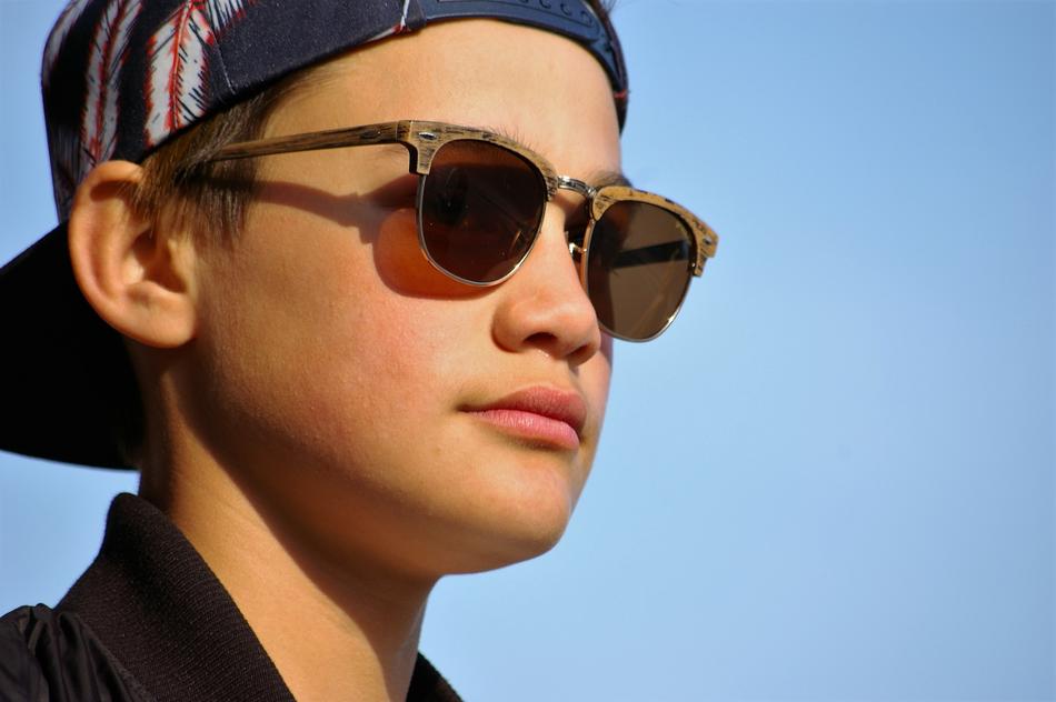 a young guy with glasses and a cap